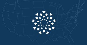 A stylized white geometric design resembling a circular burst is centered over a dark blue map outline of the United States, highlighting the complexities of U.S. law and FDA safety limits around online abortion drug sellers.