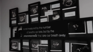 A wall display of framed ultrasound images surrounds a quote that reads: "Life is not measured by the number of breaths we take, but by the moments that take our breath away."